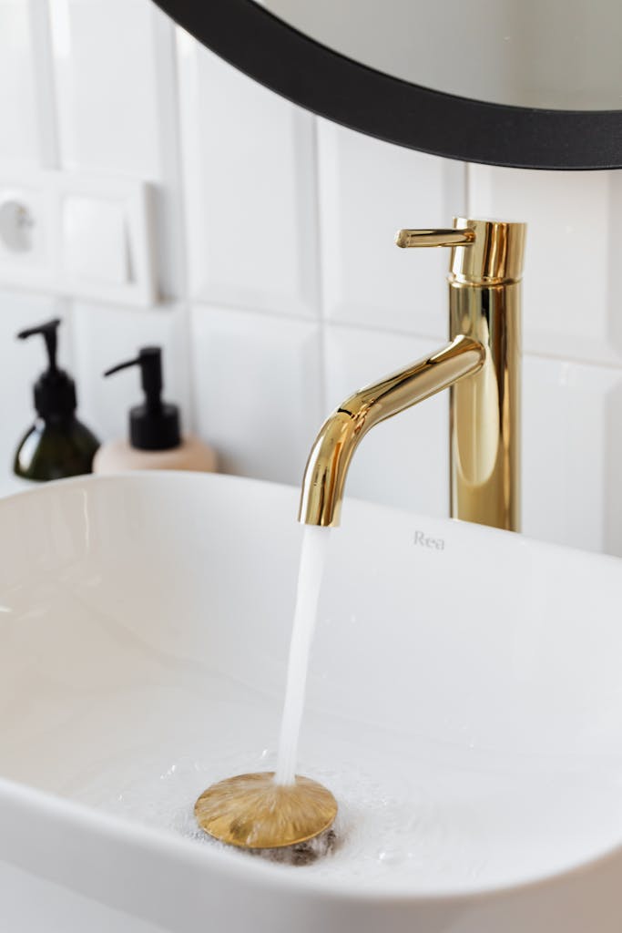 Gold faucet in a white sink.