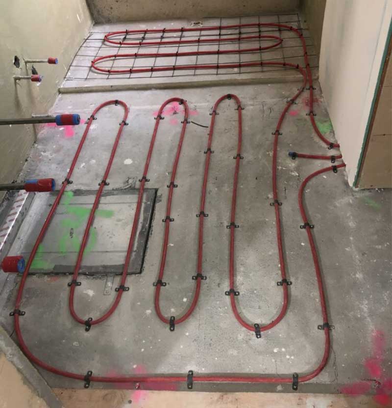 Radiant heat tubing on concrete floor.