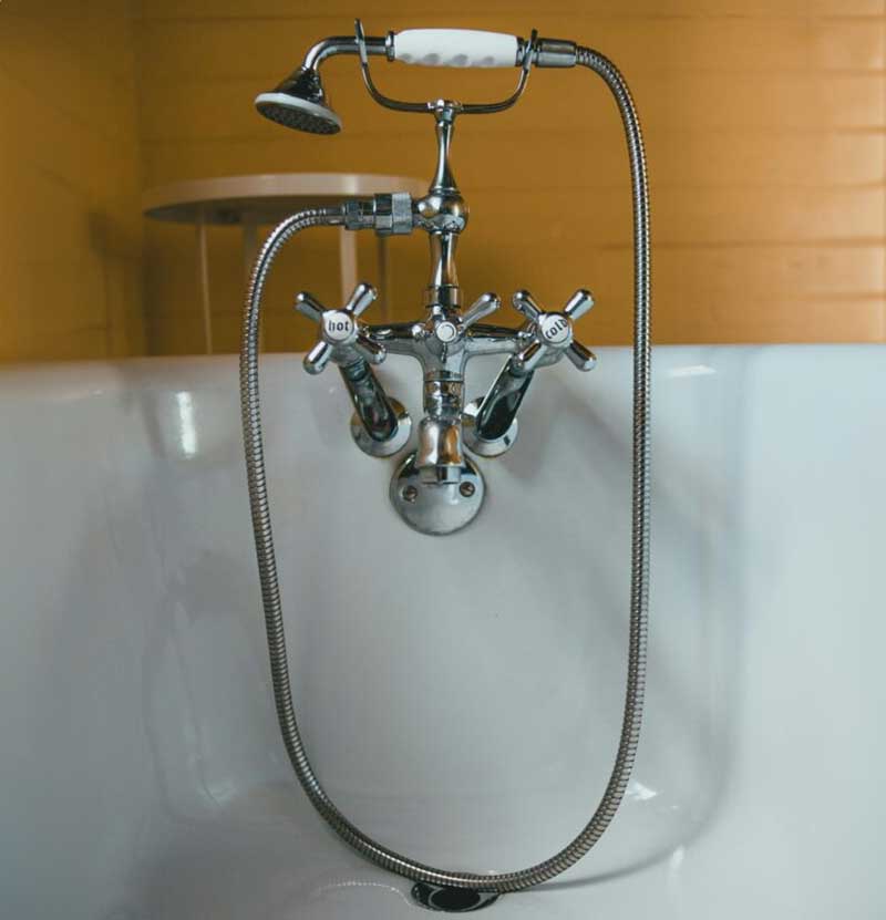 shower head and faucet in a tub.