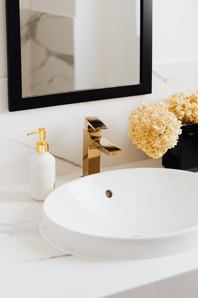 White ceramic sink with brass faucet